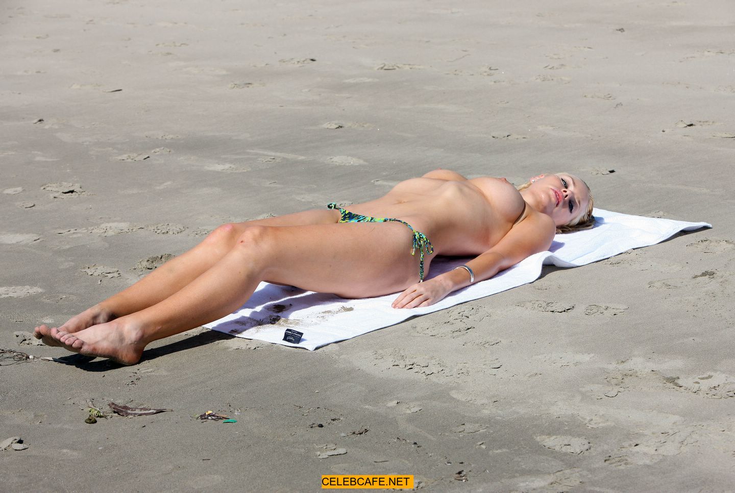 Sophie Monk in bikini and topless on a beach candids