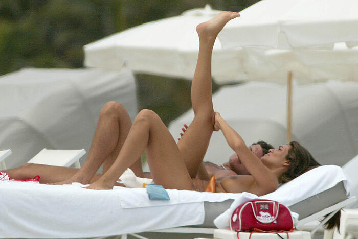 Manuela Arcuri sunbathing topless at the beach