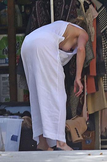 Amber Heard has tit slip while cleaning out her garage