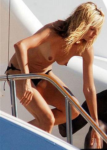 Heidi Klum caught topless on a balcony