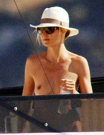 Heidi Klum caught topless on a balcony