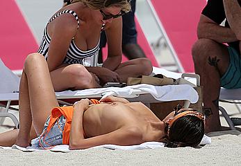 Kristen Doute topless on the beach in Miami