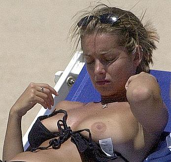 Louise Redknapp sunbathing topless on a beach