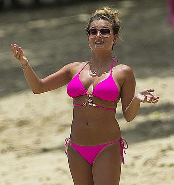 Zara Holland in magenta bikini on a beach in Barbados