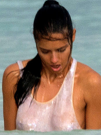 Adriana Lima in a see through wet top behind the scene of a photoshoot in Cancun