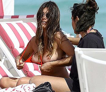 Aida Domenech changing on a beach shows her nude breasts