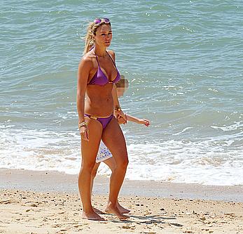 Alex Gerrard shows sexy cleavage on the beach in Portugal