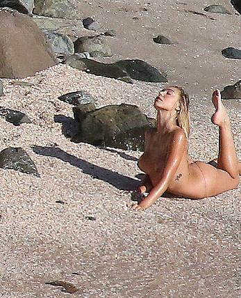 Alexis Ren topless on a beach in St.Barth's