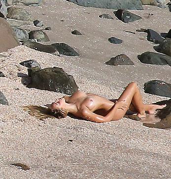 Alexis Ren topless on a beach in St.Barth's