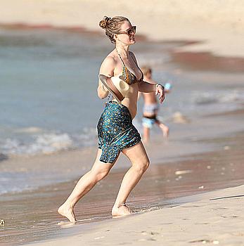 Alice Eve wearing a bikini at a beach in Barbados