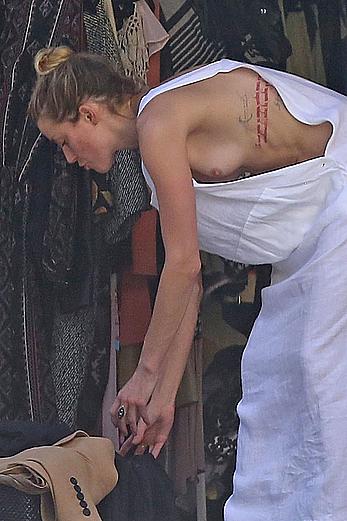 Amber Heard has tit slip while cleaning out her garage