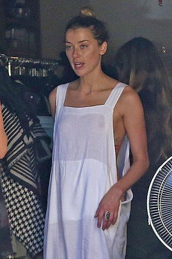 Amber Heard has tit slip while cleaning out her garage