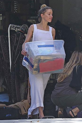 Amber Heard has tit slip while cleaning out her garage