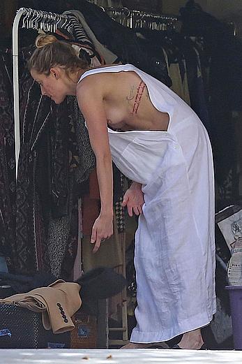 Amber Heard has tit slip while cleaning out her garage