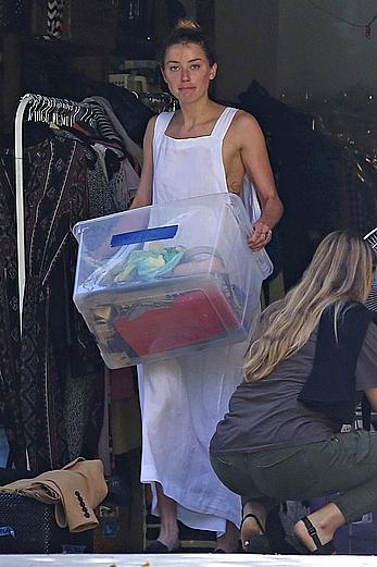 Amber Heard has tit slip while cleaning out her garage