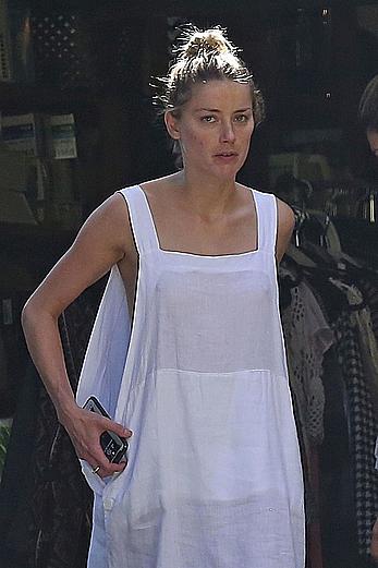 Amber Heard has tit slip while cleaning out her garage