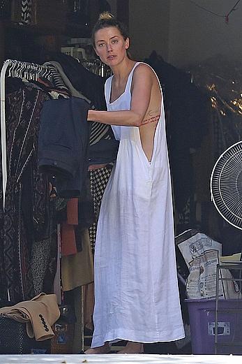 Amber Heard has tit slip while cleaning out her garage