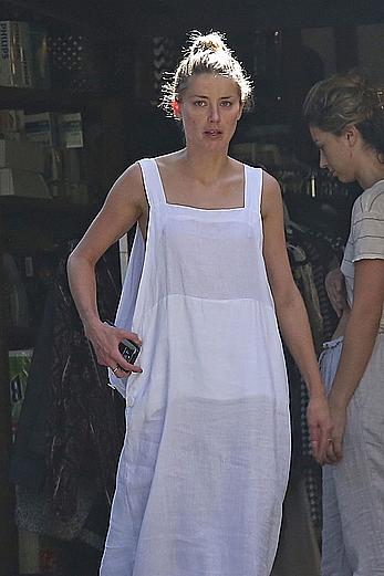 Amber Heard has tit slip while cleaning out her garage