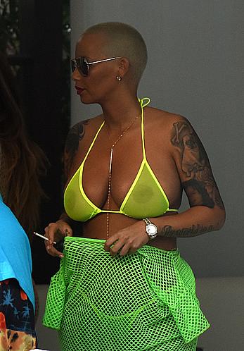 Busty Amber Rose in see through yellow bikini top by the pool in Miami