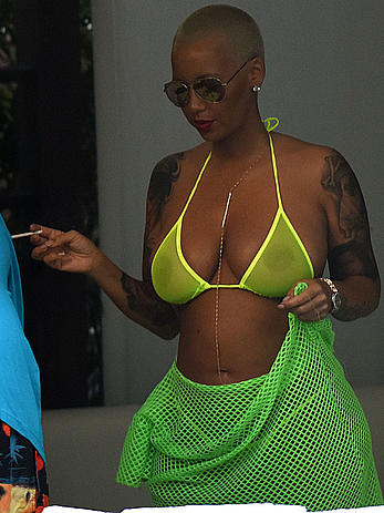 Busty Amber Rose in see through yellow bikini top by the pool in Miami