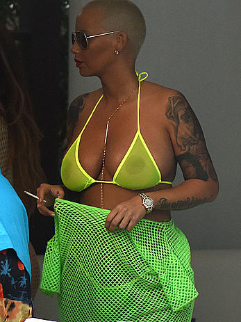 Busty Amber Rose in see through yellow bikini top by the pool in Miami