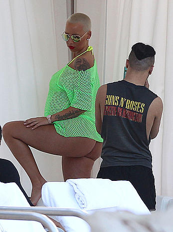 Busty Amber Rose in see through yellow bikini top by the pool in Miami