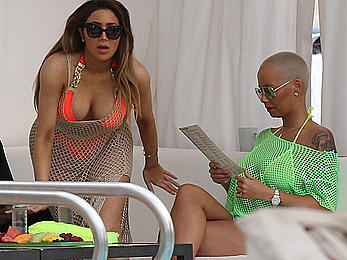 Busty Amber Rose in see through yellow bikini top by the pool in Miami