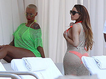 Busty Amber Rose in see through yellow bikini top by the pool in Miami