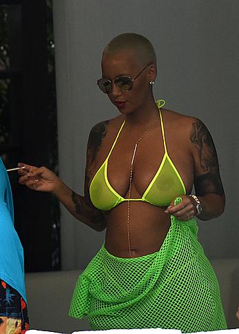 Busty Amber Rose in see through yellow bikini top by the pool in Miami