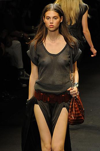 Anais Pouliot in see through dress at fashion show runway