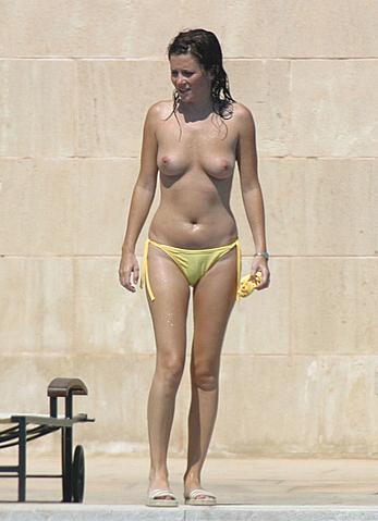 Anna Friel topless in yellow pants on a beach