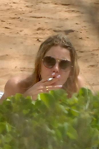 Ashley Benson caught topless at the beach in Hawaii