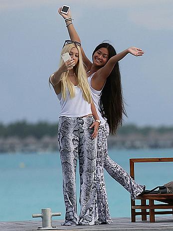 Ava Sambora paddle boarding on vacation in Bora Bora