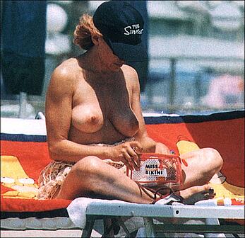 Barbara d'Urso topless on a bech paparazzi shots