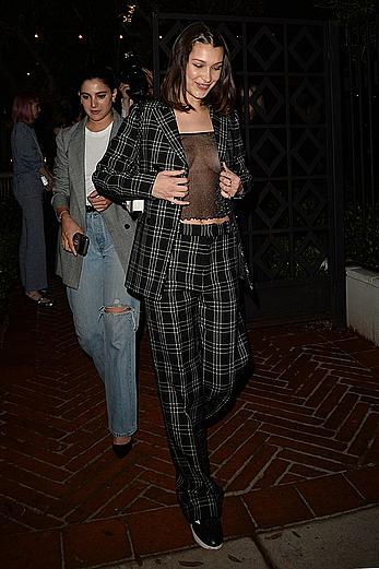 Bella Hadid braless under see through top