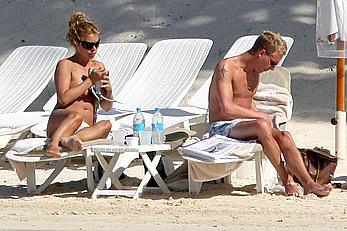 Billie Piper sunbathing topless on a beach