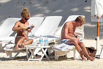 Billie Piper sunbathing topless on a beach