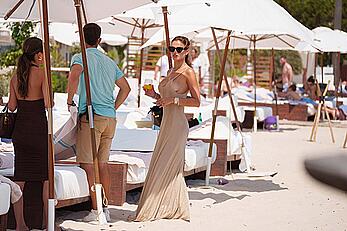 Brooks Nader sideboob while spotted having a drink at a beach club in Ibiza