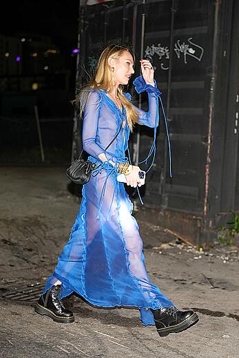 Candice Swanepoel stuns in a braless blue sheer dress at Anitta's birthday party in Miami