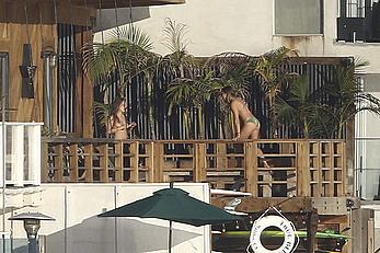 Cara Delevingne sunbathing topless on a balcony in Malibu