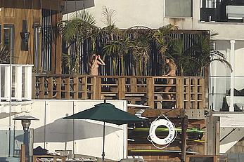 Cara Delevingne sunbathing topless on a balcony in Malibu