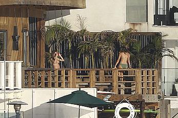 Cara Delevingne sunbathing topless on a balcony in Malibu