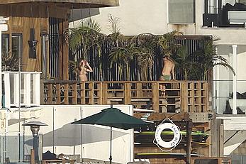 Cara Delevingne sunbathing topless on a balcony in Malibu