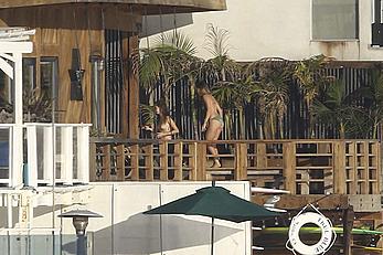 Cara Delevingne sunbathing topless on a balcony in Malibu