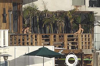 Cara Delevingne sunbathing topless on a balcony in Malibu