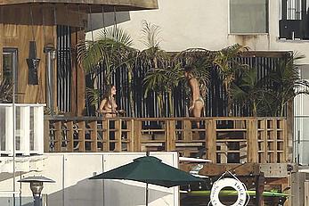 Cara Delevingne sunbathing topless on a balcony in Malibu