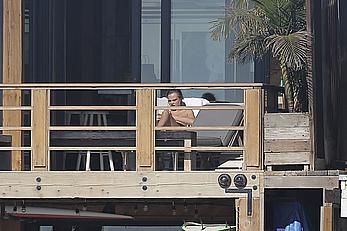 Cara Delevingne sunbathing topless on a balcony in Malibu