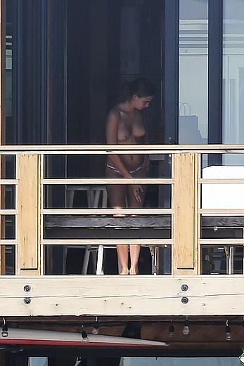 Cara Delevingne sunbathing topless on a balcony in Malibu