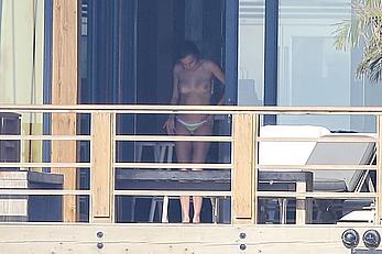 Cara Delevingne sunbathing topless on a balcony in Malibu