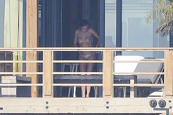 Cara Delevingne sunbathing topless on a balcony in Malibu